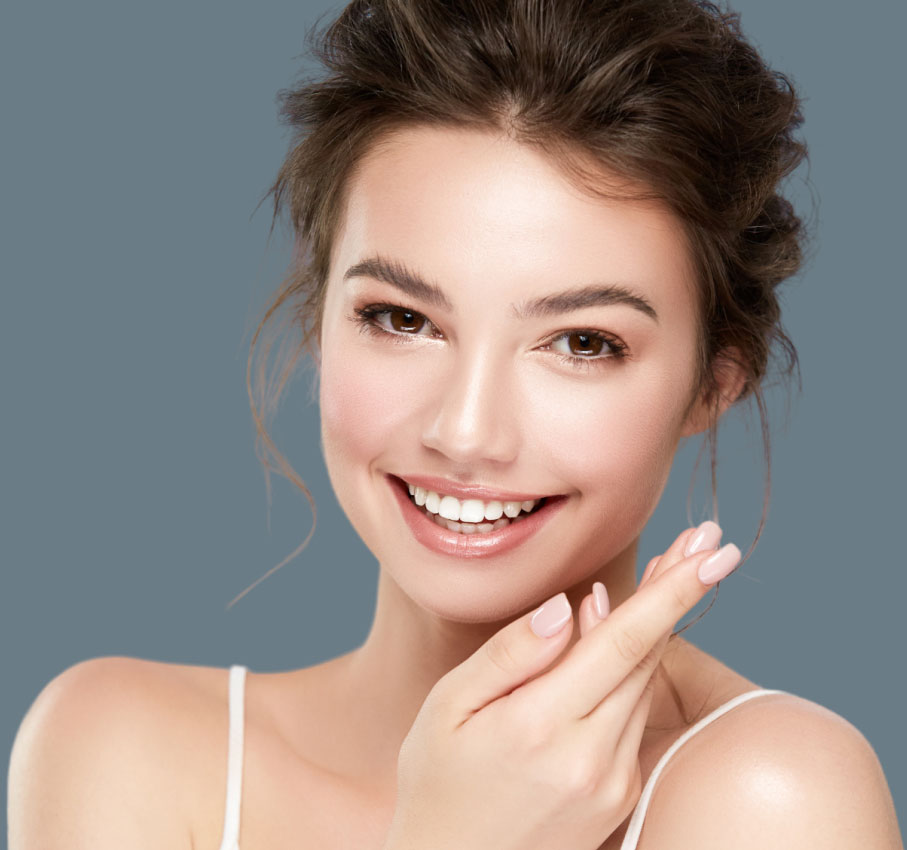 Stock image of Model Smiling with Hands Gracefully Below Chin